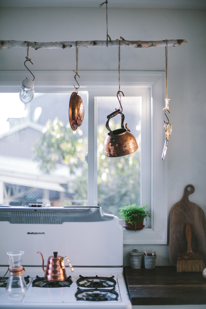 Before and After: A Modern Rustic Kitchen Makeover - Copper pots on a DIY branch hanger